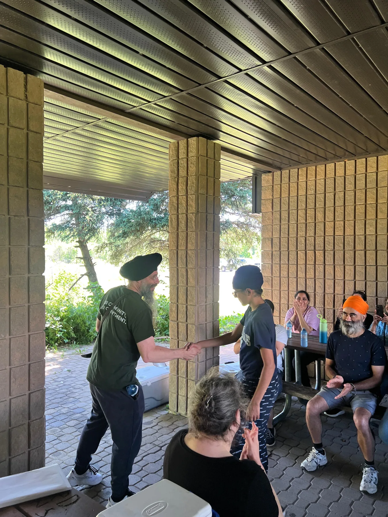 A Progress Peel student receiving recognition during an outdoor gathering