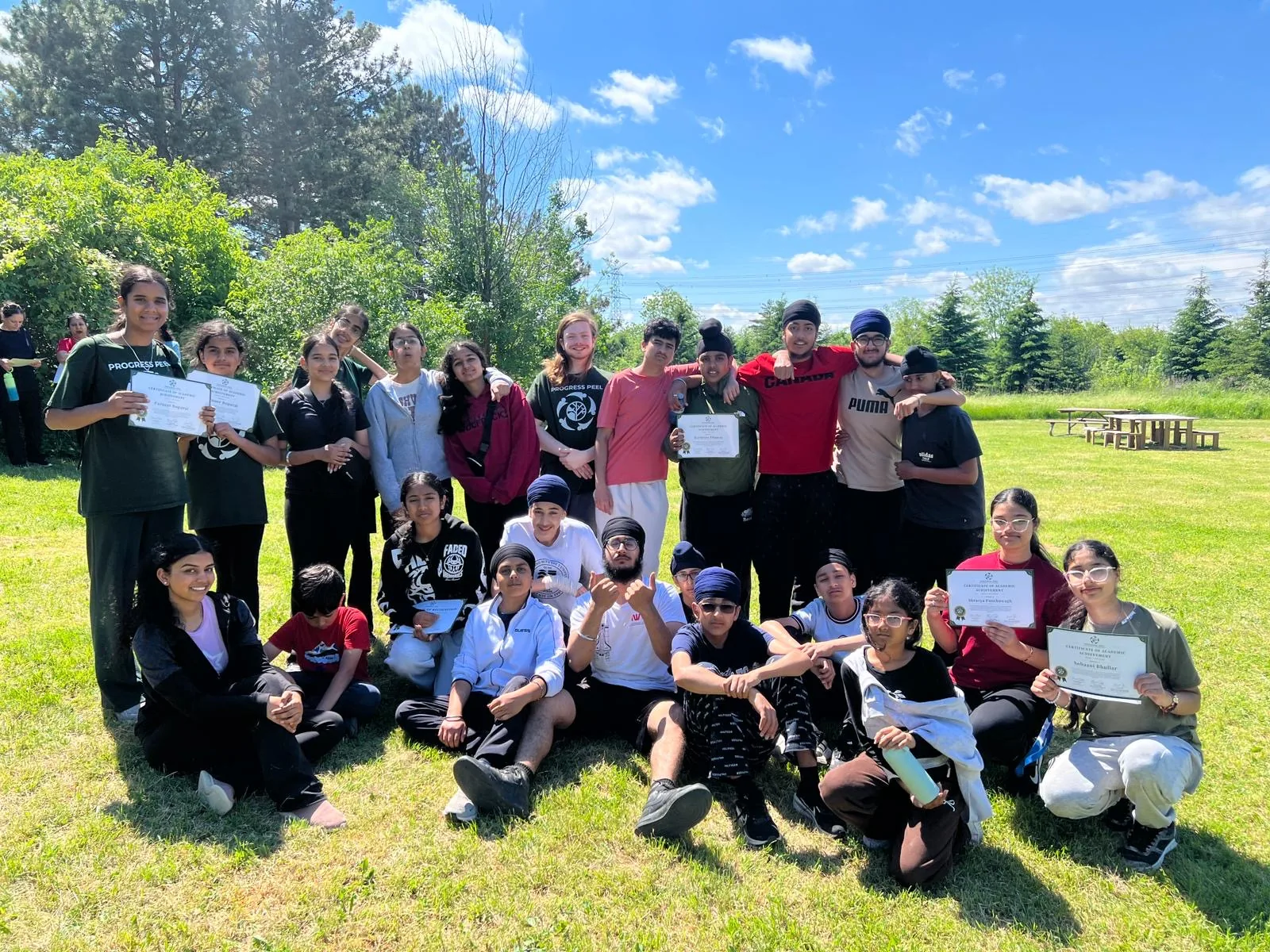 Progress Peel students holding certificates outdoors