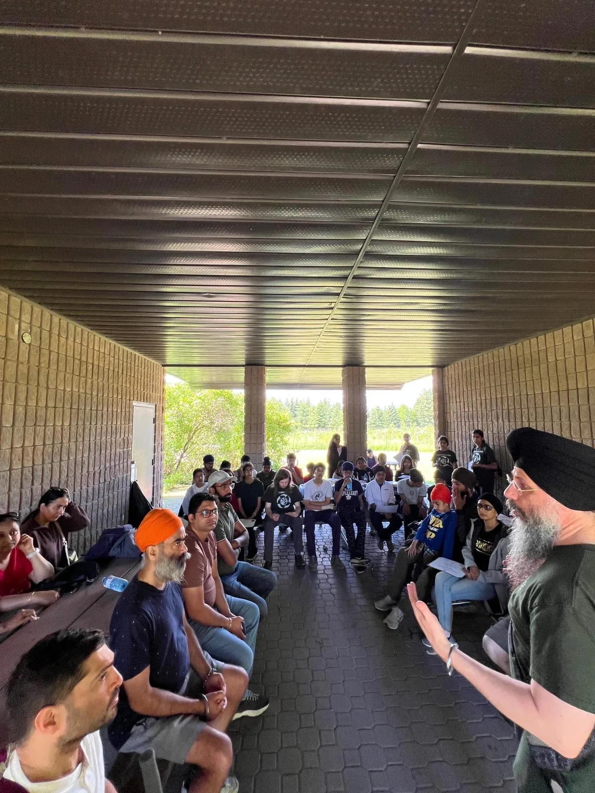 Progress Peel adult volunteers speaking with students and parents during a program gathering